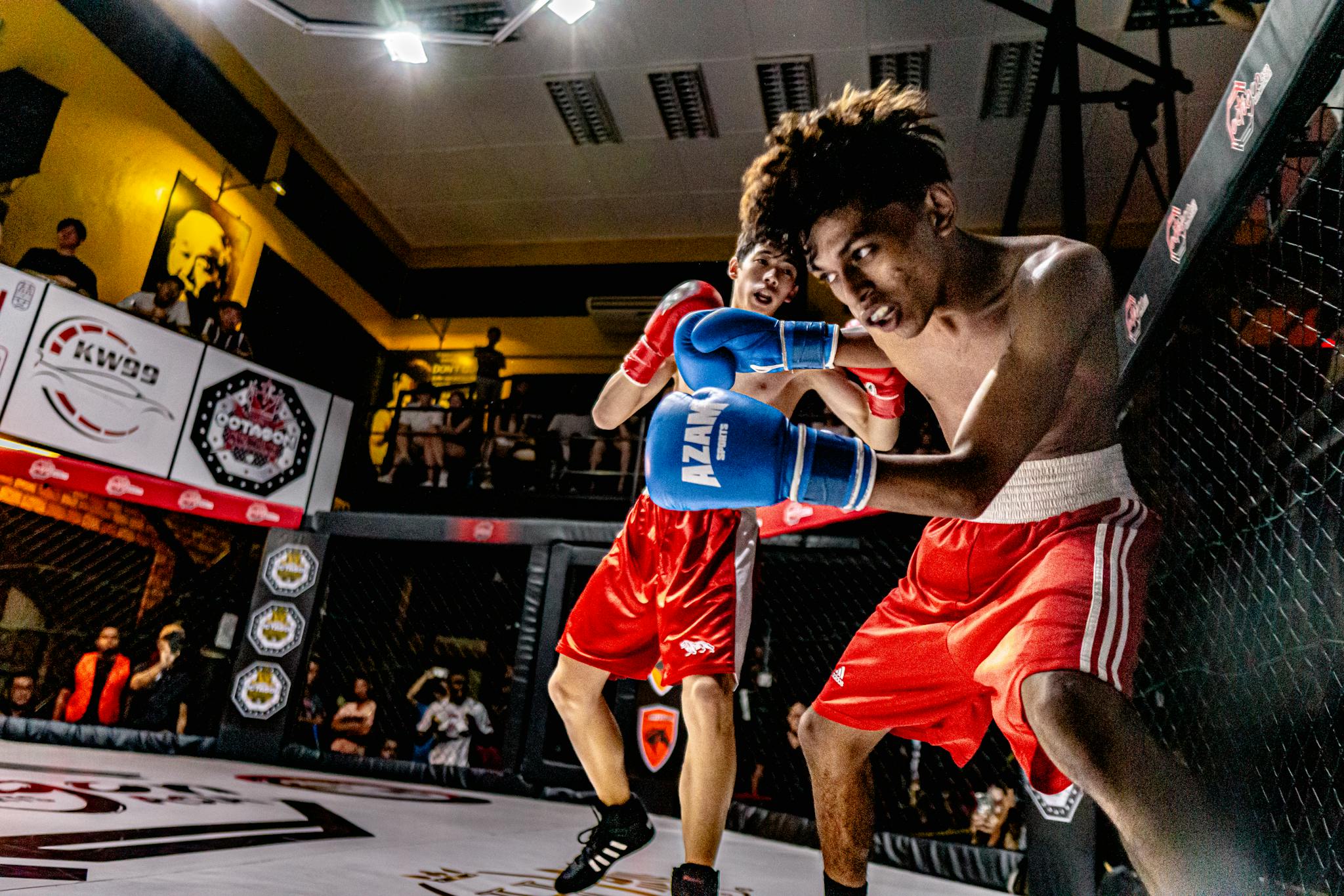 A dramatic MMA fight captured in George Town, Malaysia, showcasing action and athleticism.