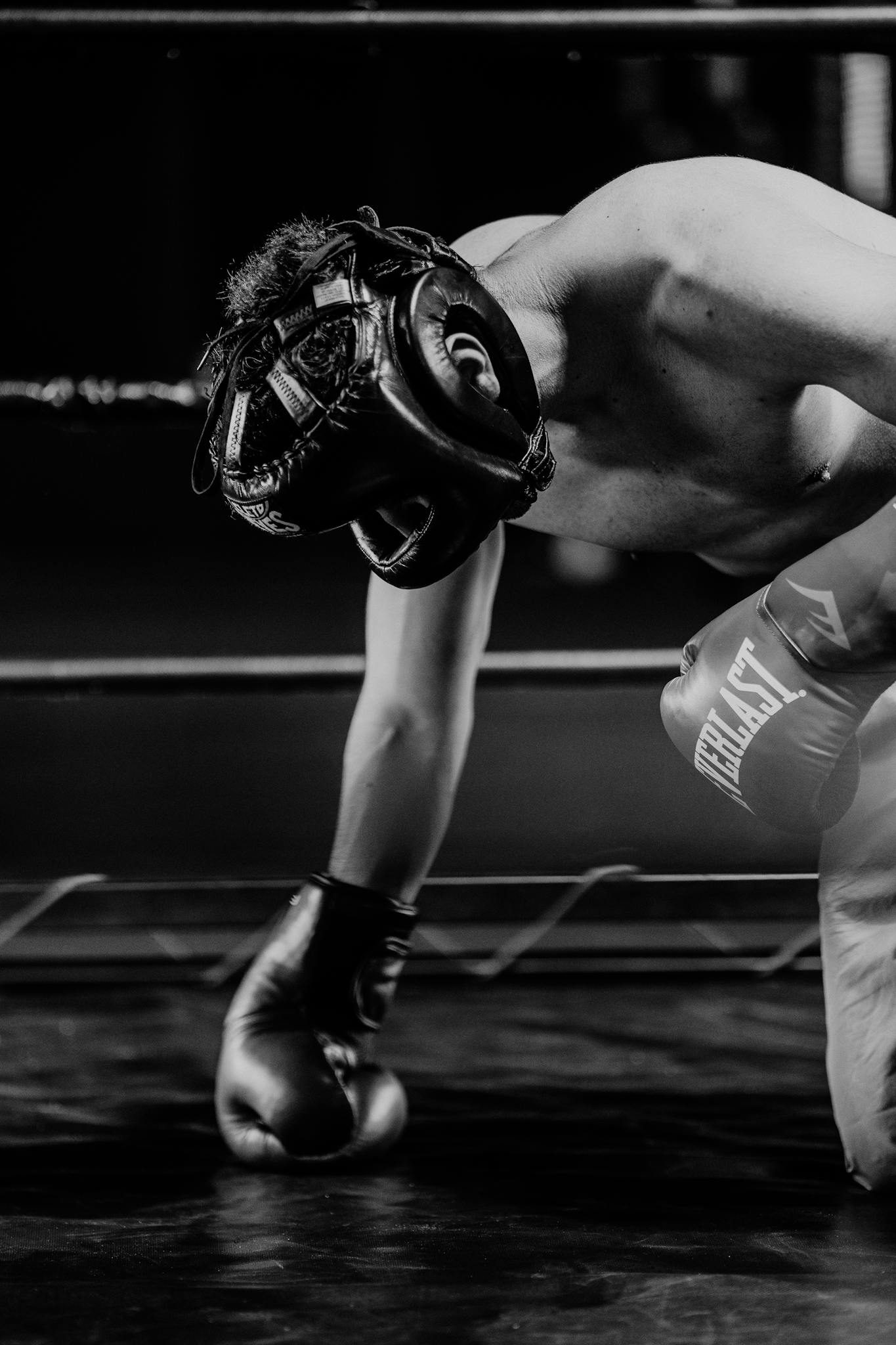 A focused boxer in a ring, showcasing strength and resilience.
