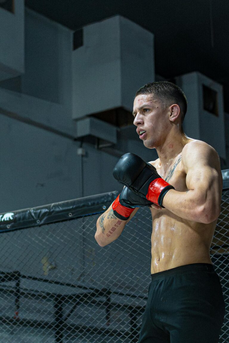 Intense focus of MMA fighter during training session in Buenos Aires gym.