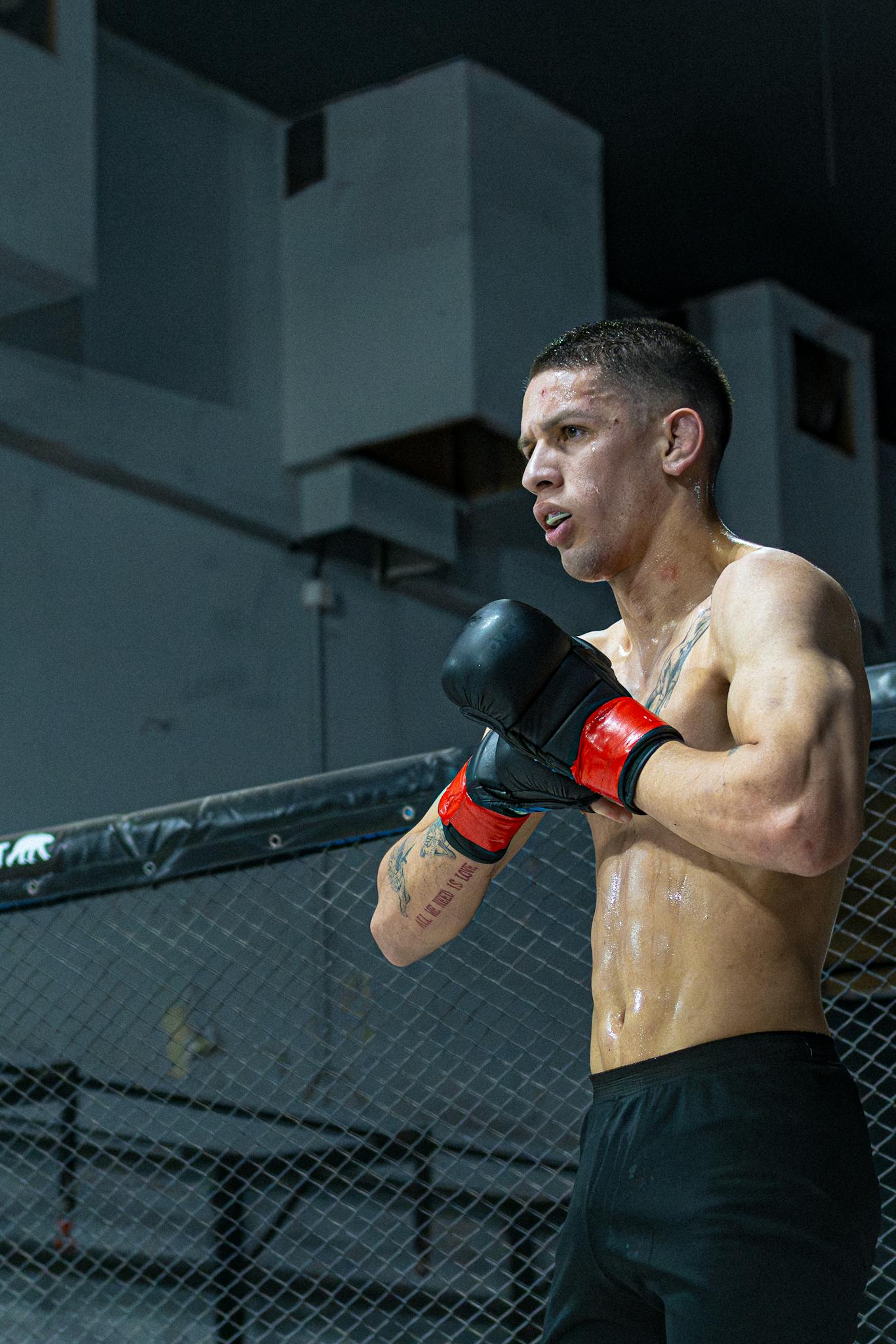 Intense focus of MMA fighter during training session in Buenos Aires gym.